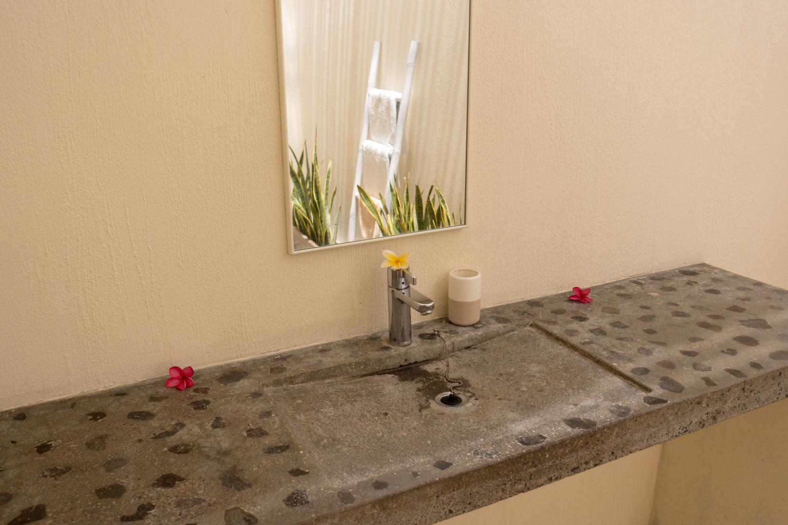 Master bedroom sink and towel rack in the mirror