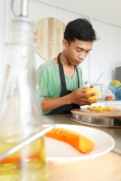 Cutting a pineapple for the fruit platter