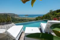 Villa Atas Pelangi pool with lounge chairs and beautiful scenery